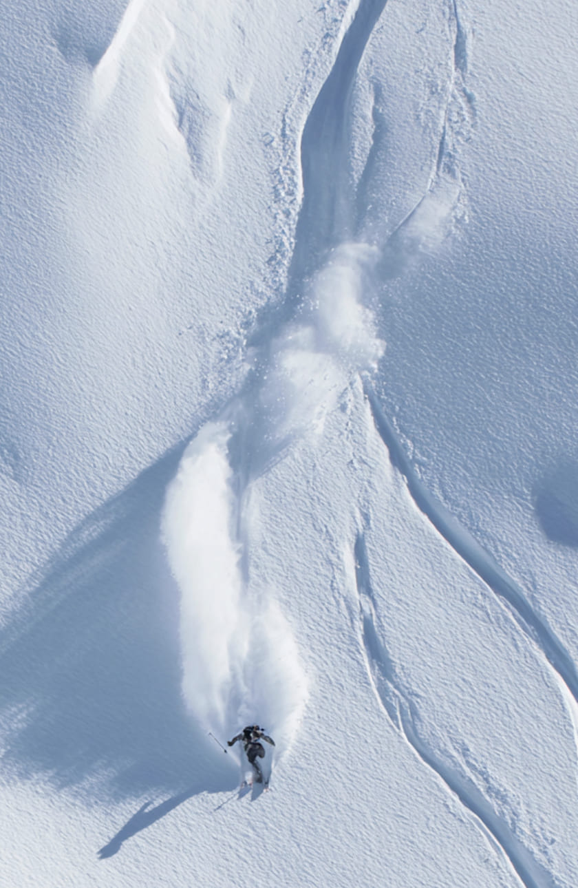 An image of a skier coming down a slope alone