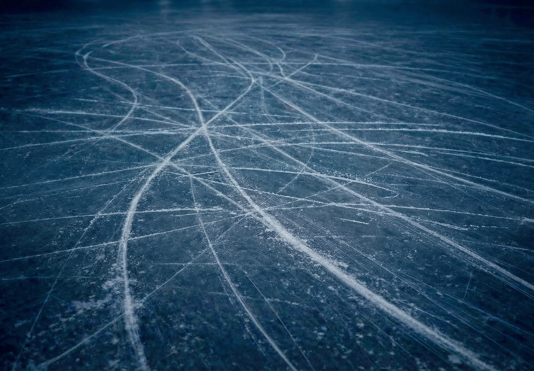 An image of an ice rink surfaced scratched by skate blades