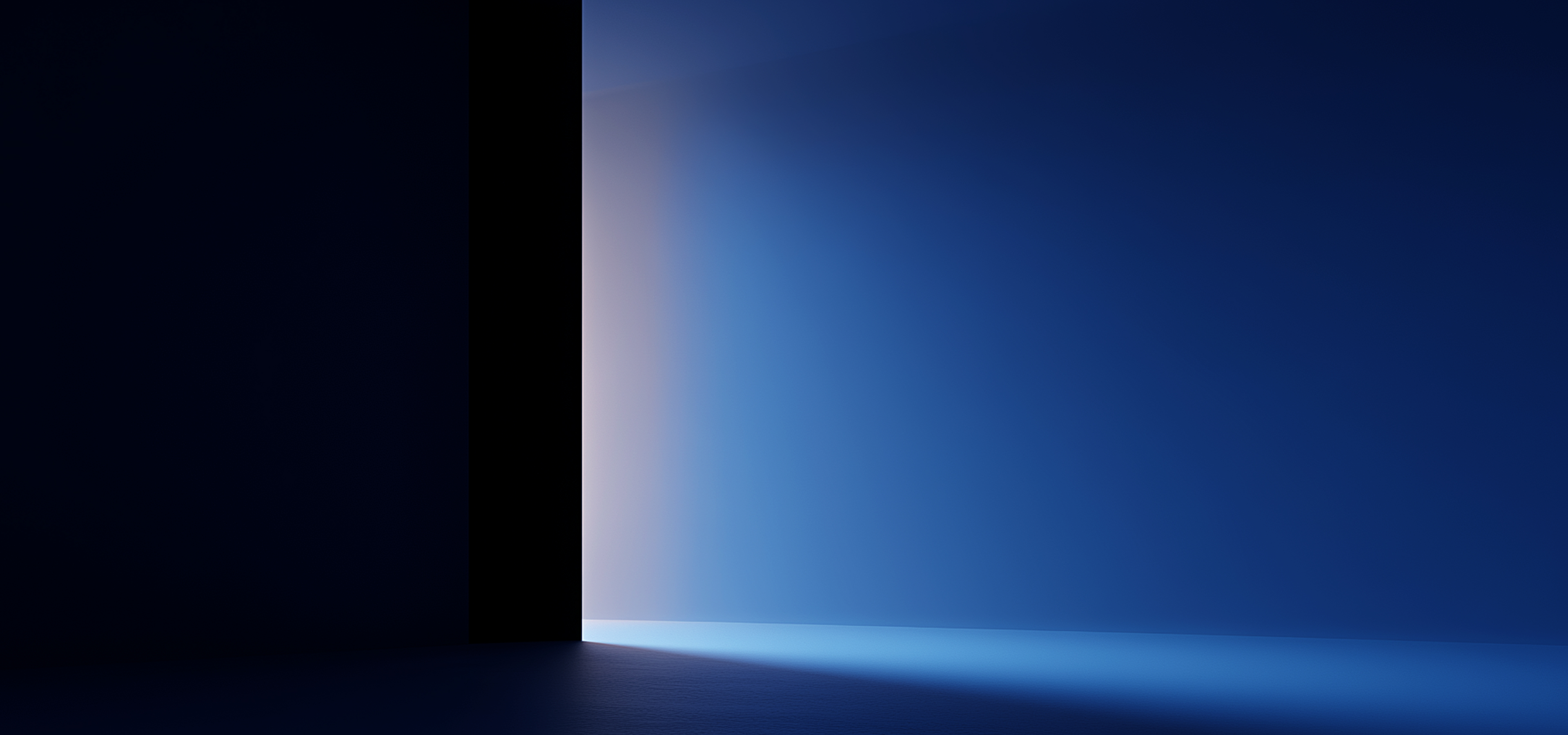 Light in shades of blue and soft white streaming through a doorway into a dark room, illuminating the floor and wall.