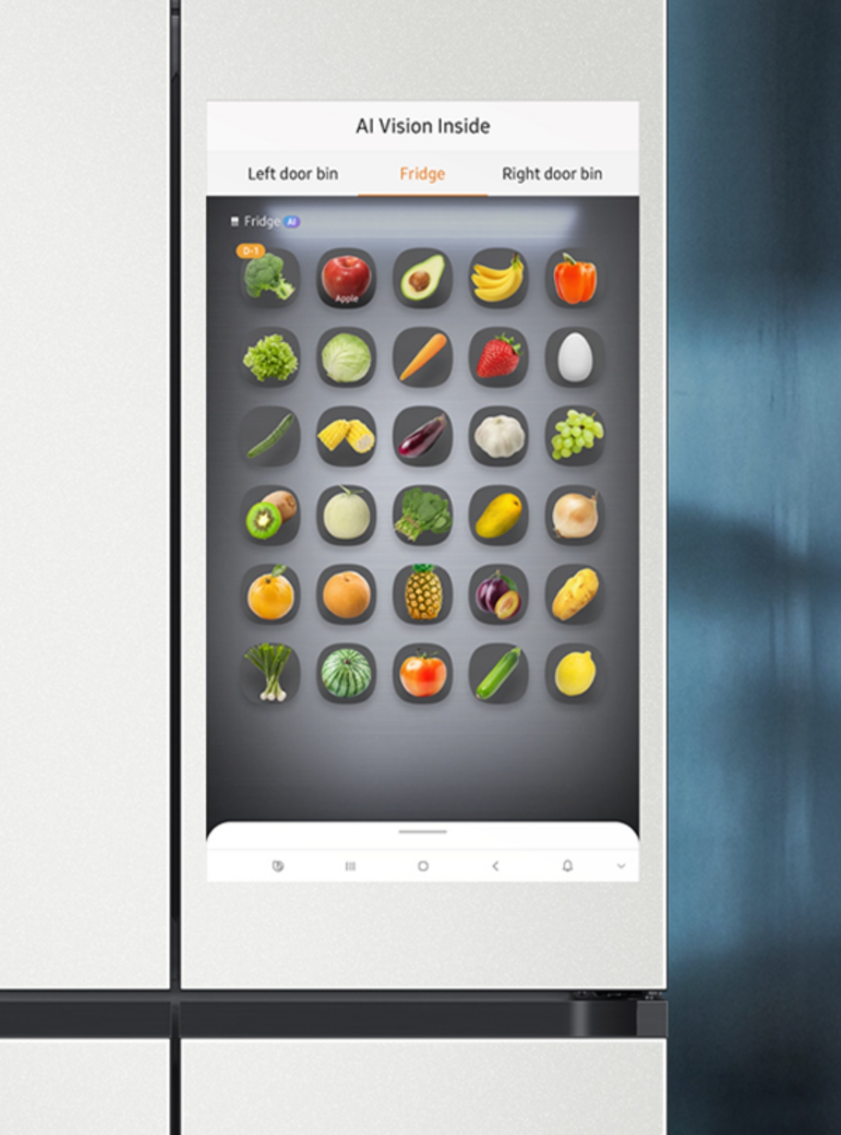 On the monitor to the right of the refrigerator, you see the Ai Vision Inner Space. At the top, there are item buttons labeled Left Compartment, Freezer, and Right Compartment. This images of various vegetables and fruits.