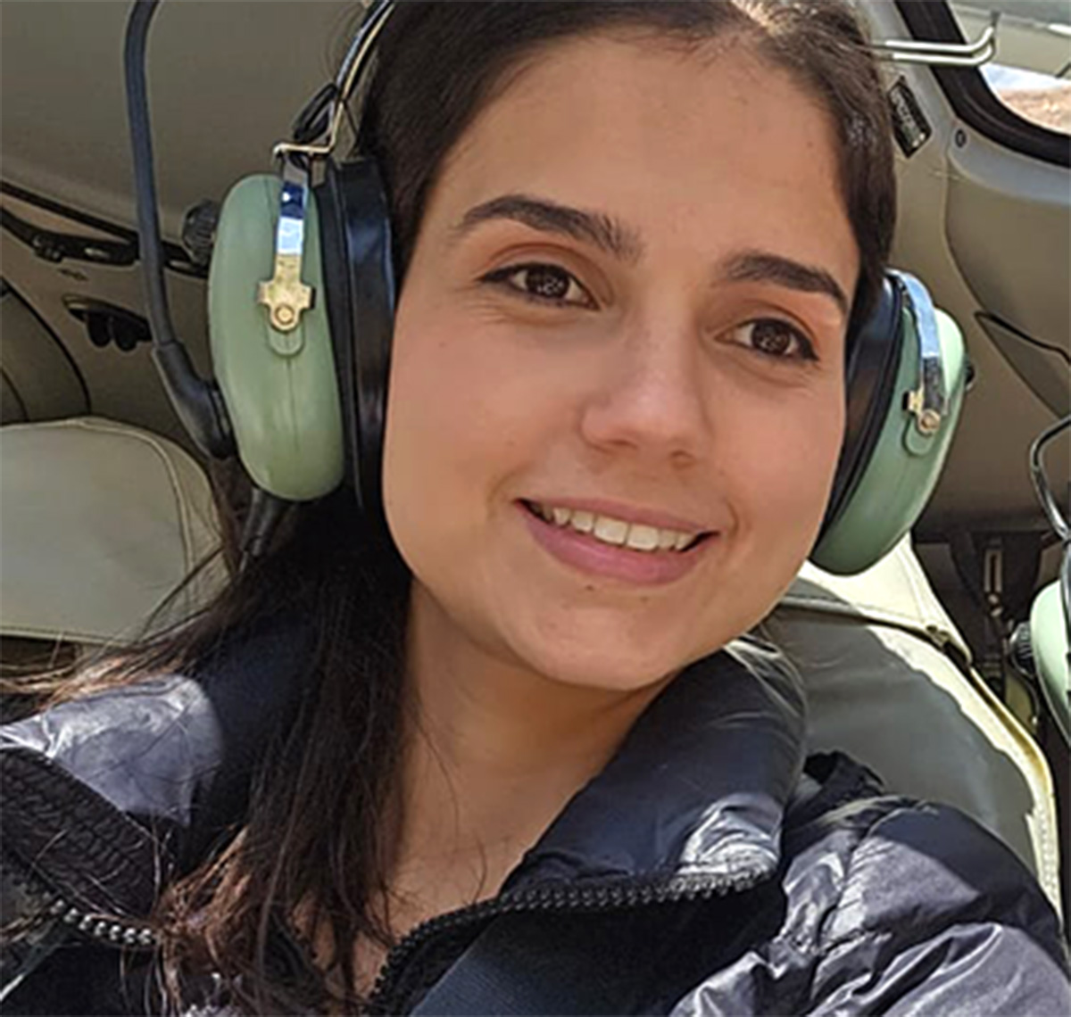 A selfie of a woman on a helicopter tour.