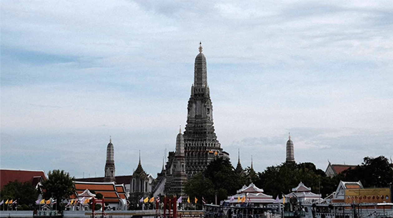 Several bronze Buddha statues are displayed in a row inside the Buddhist temple Wat Arun.