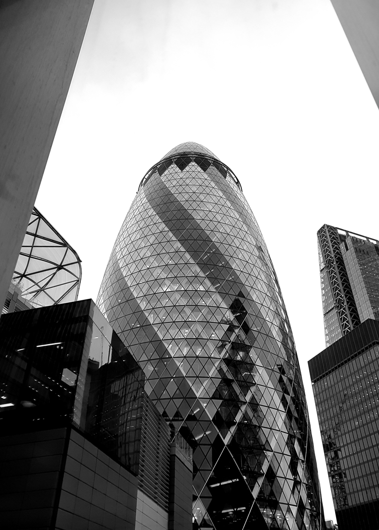 London's modern landmark, 'The Gherkin,' stands out with its unique curves and geometric glass patterns, defining the city's skyline.