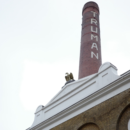 The iconic chimney of the Truman Brewery, with its bold ‘T.R.U.M.A.N.' lettering on red brick, stands as a timeless reminder of its historic legacy.