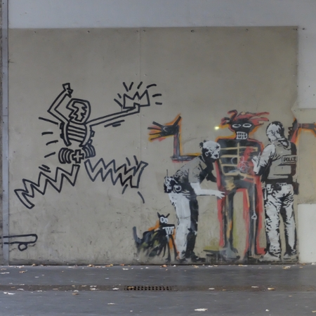 Graffiti art painted on a wall, featuring bold lines and unique characters that image of depiction of figures and robots.