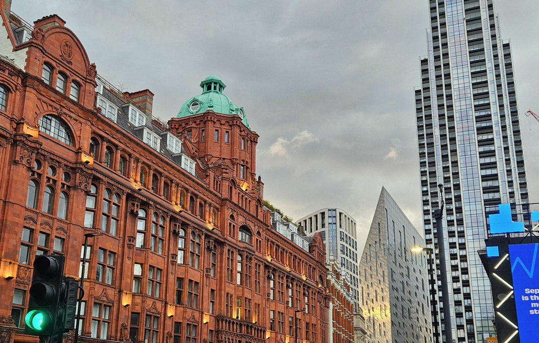 Classic red-brick architecture stands alongside modern skyscrapers, illustrating a cityscape where the past and present coexist harmoniously.