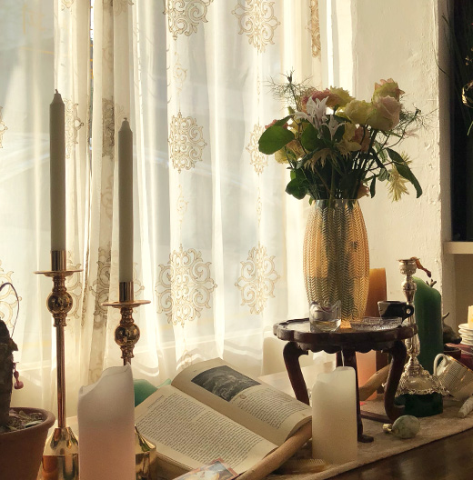 Candle stick and pots lying on the table.