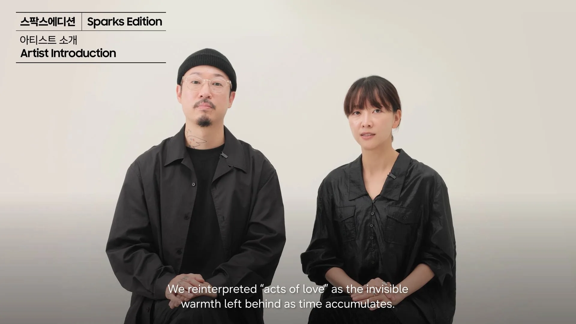 Sparks Edition artist introduction video thumbnail showing two people seated side by side against a light background.