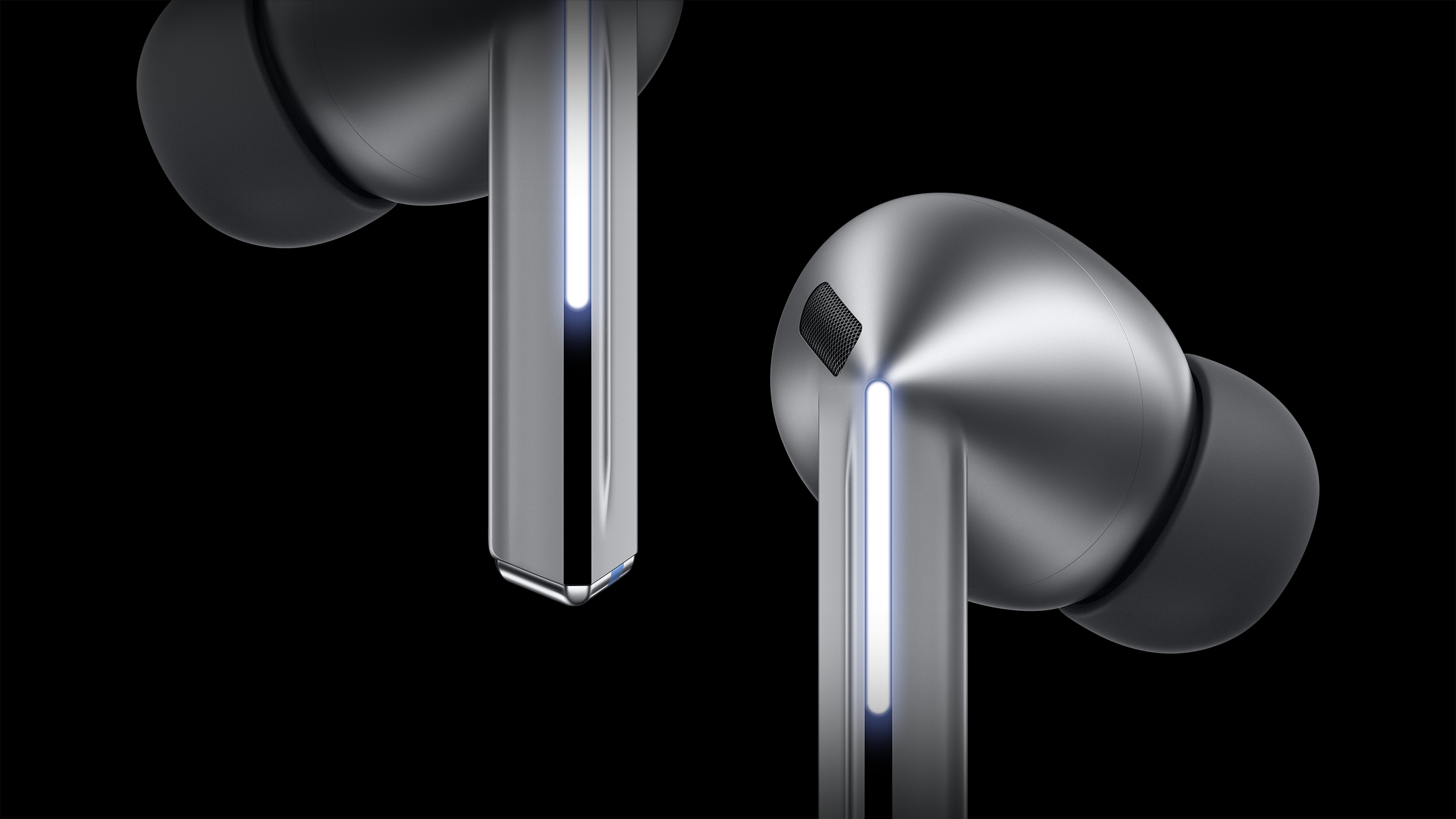 A pair of Galaxy Buds3 Pros are shown on a black background, flanked by a height difference between the top and bottom. The Galaxy Buds3 Pro has a straight line of light shining on the rod (blade) that runs down the cone head. The black straight line corresponding to the blade light runs from the beginning of the bar to the end, and only 60% of the straight line's length is illuminated.