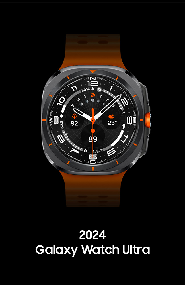 Front view of the Galaxy Watch Ultra with the orange strap (marine band).  The four corners are rounded and curved (a new sculptural design for the Ultra Watch called a cushion), and within the circular border are twelve graduations of orange dots aligned with the hour positions. The hands on the inner watch face point to the eight o'clock position, and the second hand with orange dots is at six o'clock.