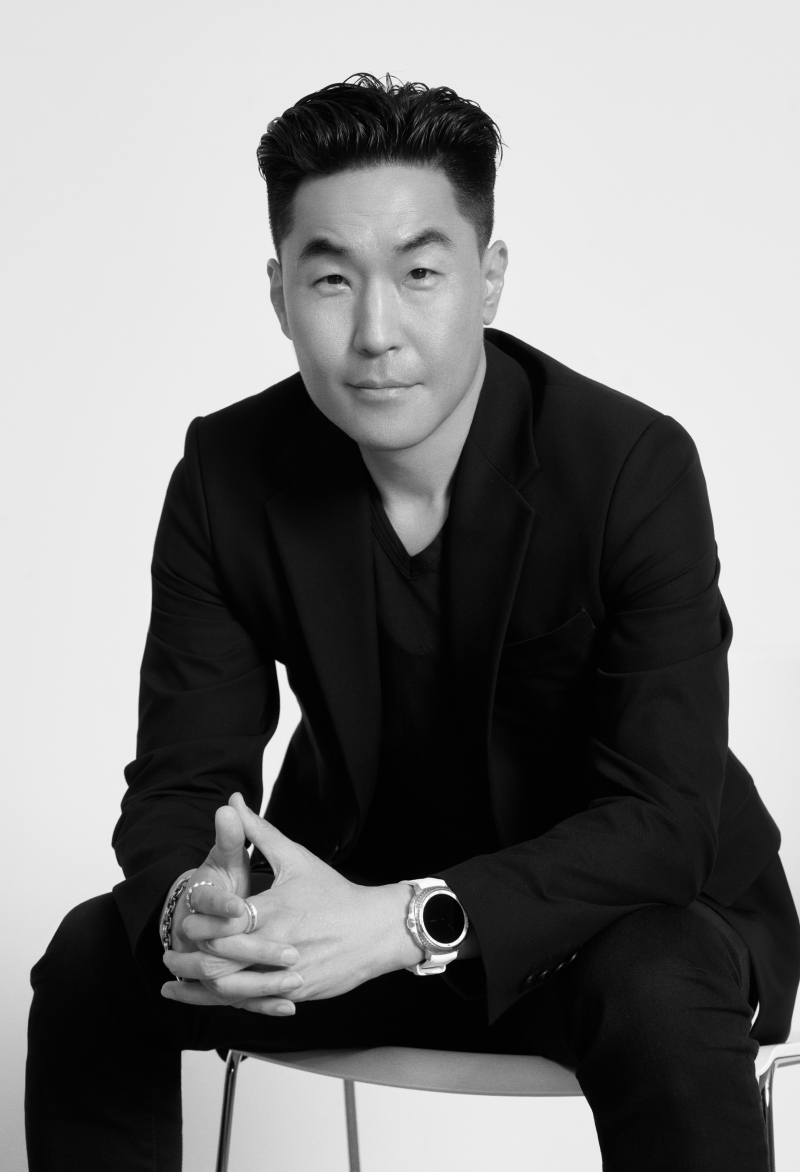 Hubert Lee, Head of Design Team in the MX Division, seated with both hands clasped together.