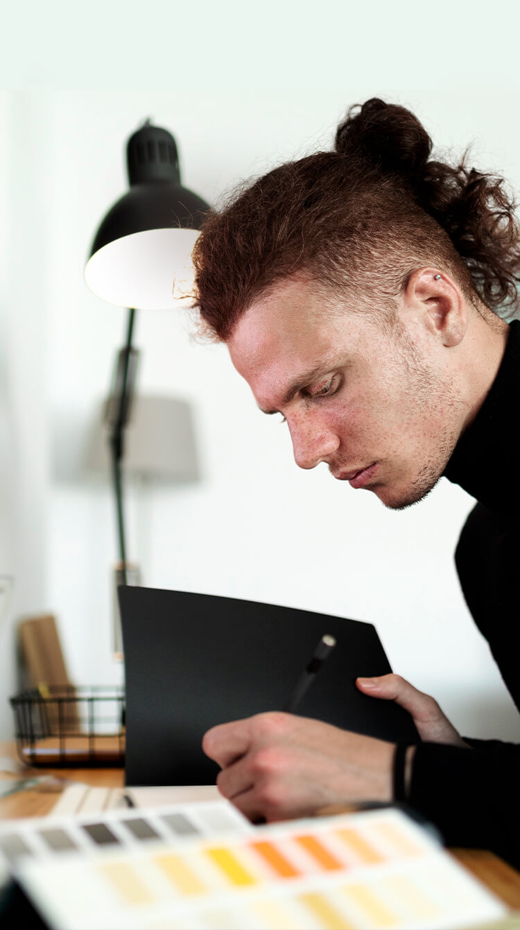 A side view of a young man as a cover image of Work section.