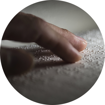 An image of hand reading Braille