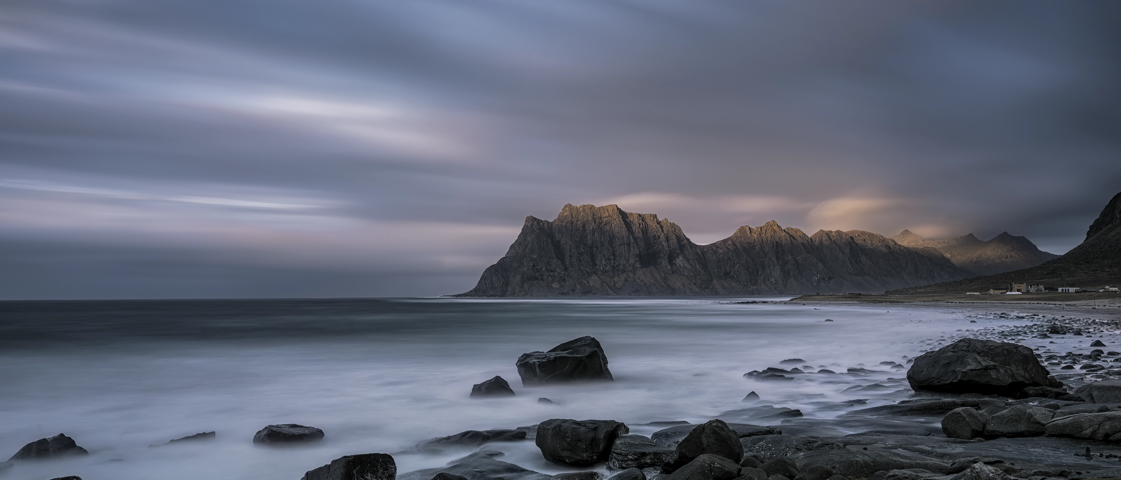 A Samsung XR interaction showing a natural image with a dark sky, sea, large rocks, and mountain ridges gradually zooming in.