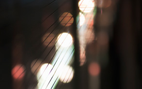 Futuristic metal wires with dramatic lights in the background.