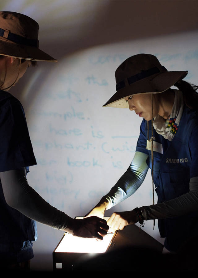 An image shows two Samsung workers adjusting the Shiny Projector