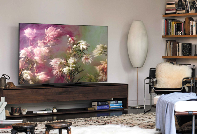 This is an image of a living room with a Samsung QLED TV in it.