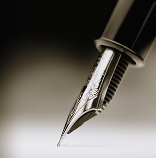 A fountain pen is placed on paper.