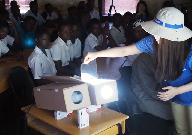 An animation fades-in to show an image of happy children as a Samsung employee controls the Shiny Projector