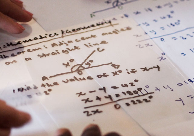 An image shows math equations written on OHP Film